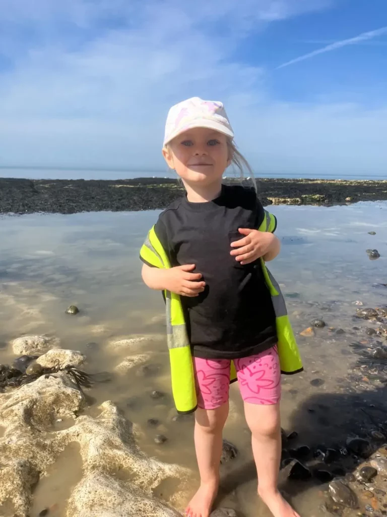 A child at the beach smiling