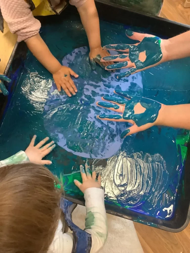 Children painting with their hands