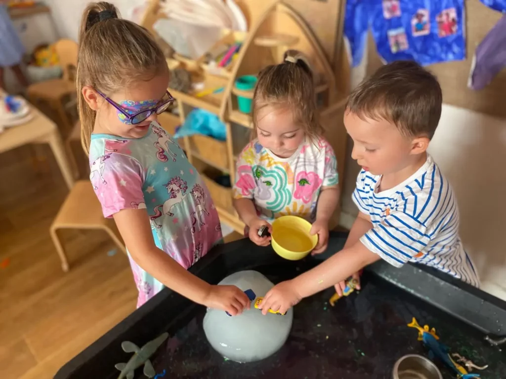 Children playing together with cars