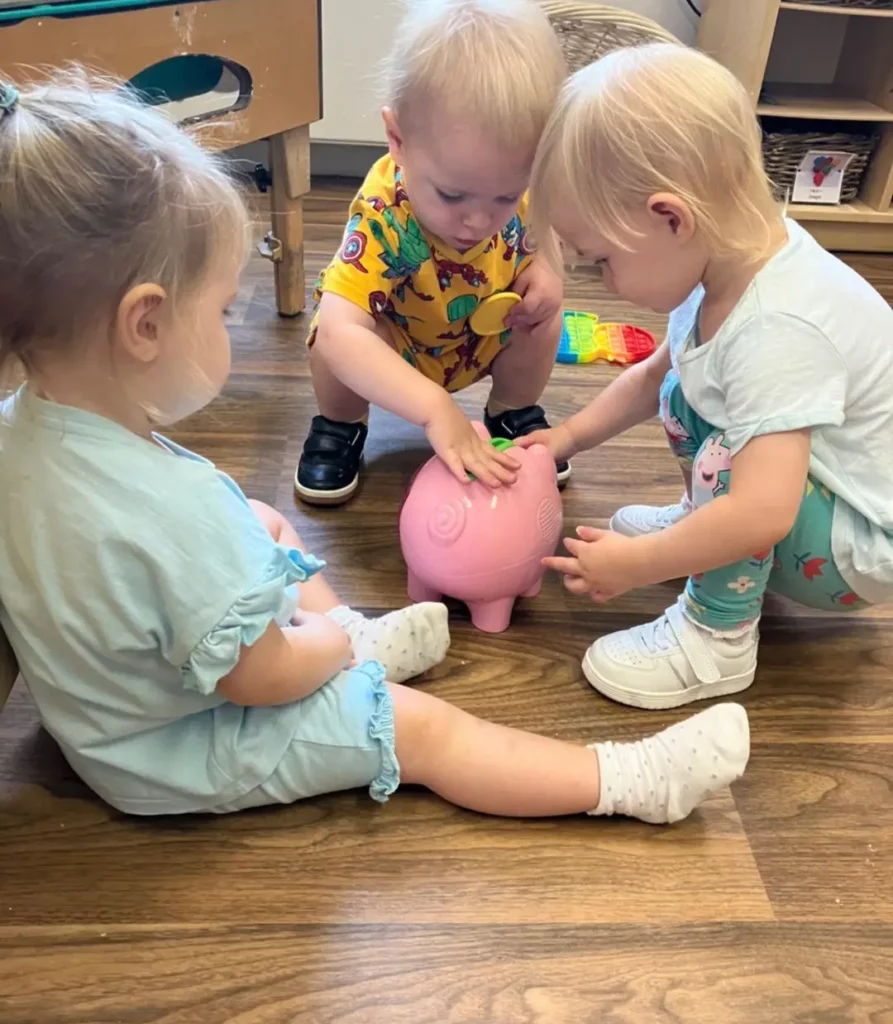 Children playing with a toy pig