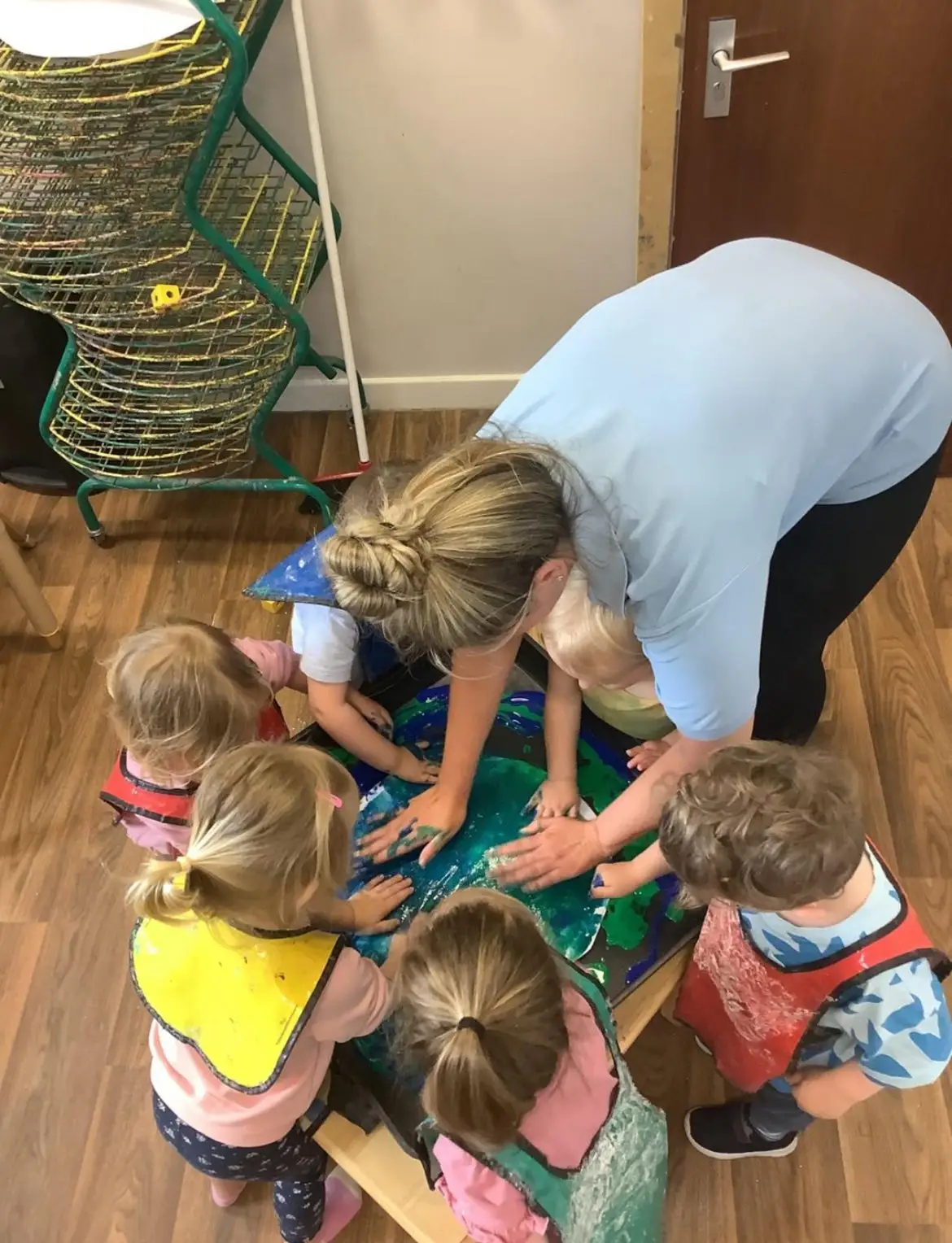 Kids and staff painting with their hands