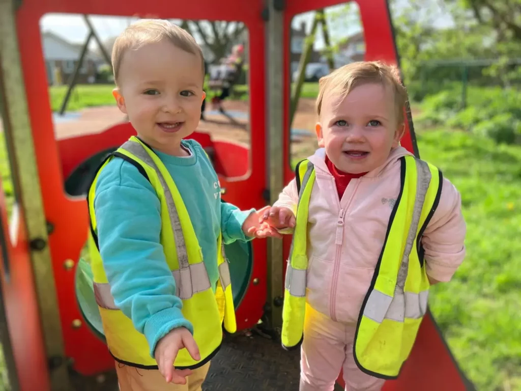 Two children holding hands outside